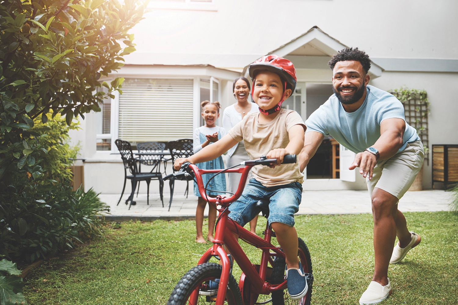 kid riding bike with family